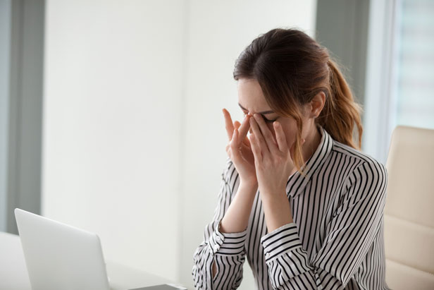 Woman with headache caused by dry eye