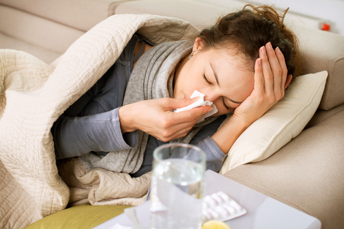 woman lying in bed sick 