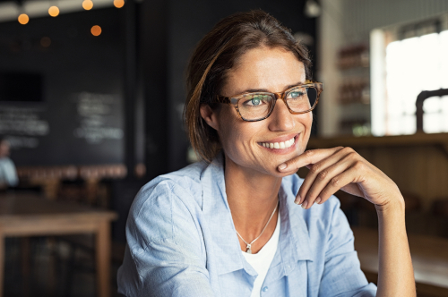 Woman Sitting In Cafeteria Looking Away