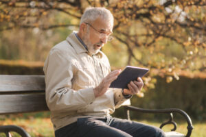 older man using tablet