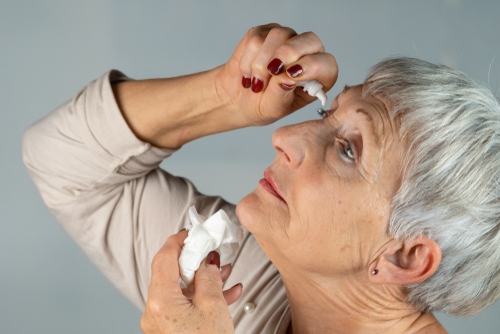 woman receiving eye drops