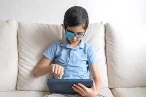 boy with eye patch playing games