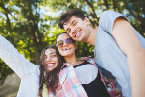 group of three friends laughing