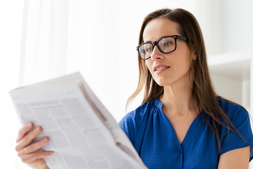 Business woman reading a newspaper